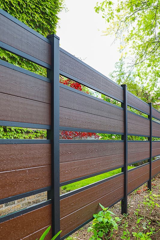 Perimtec aluminum privacy fence panels across a finished residential boundary.