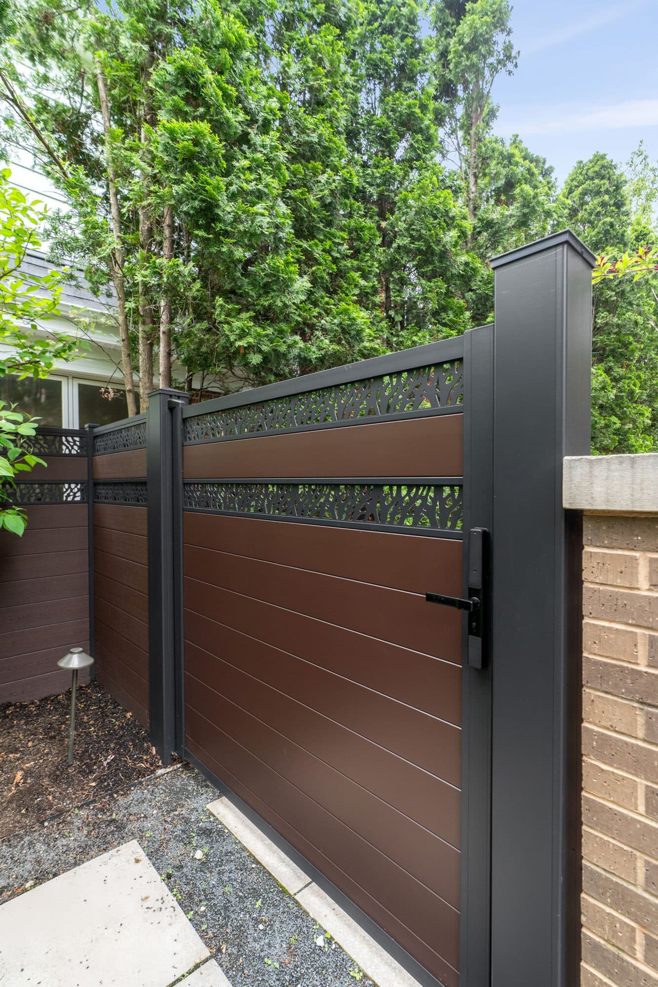 Architectural aluminum gate system with ornamental lattice infill.