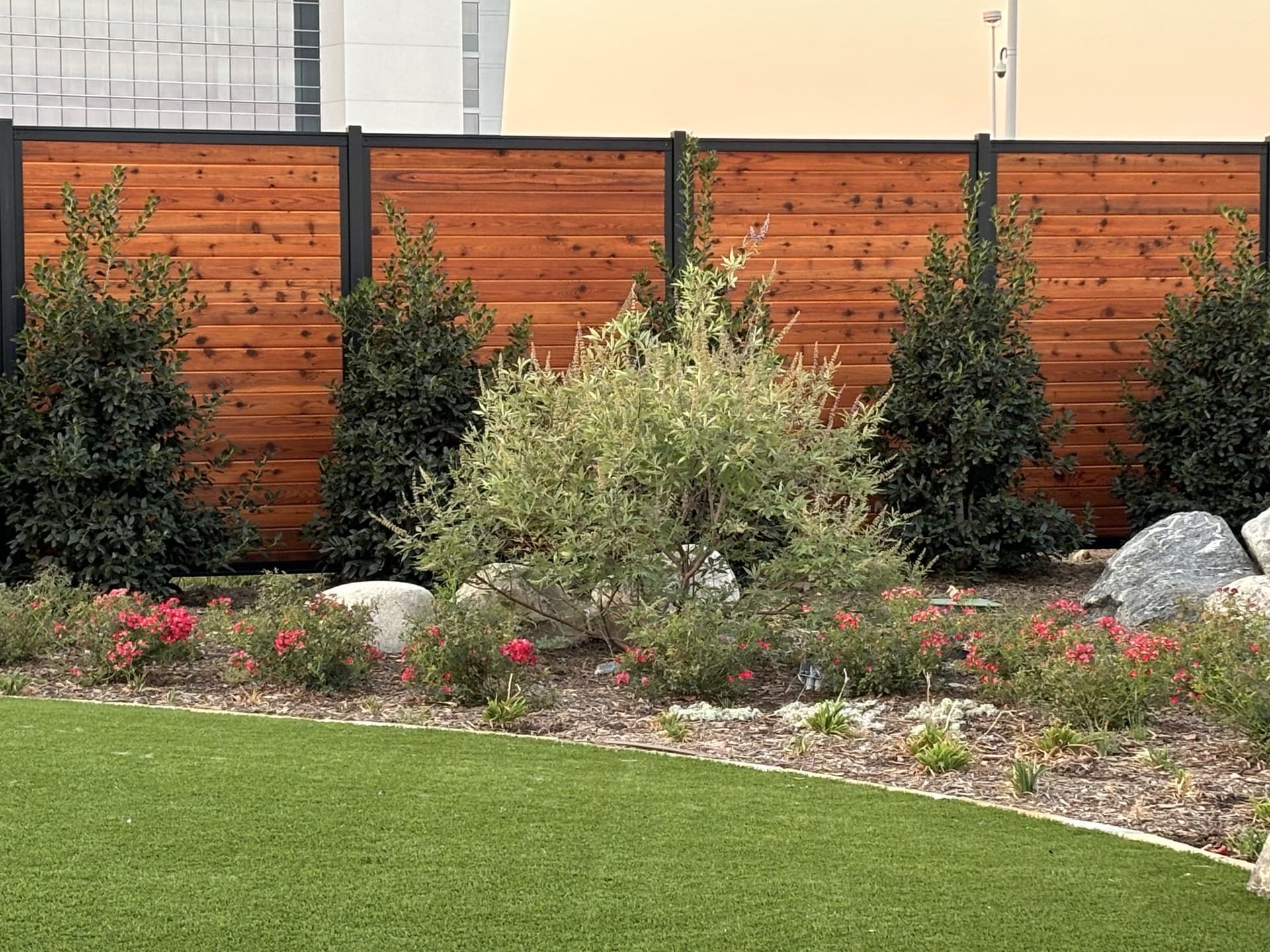 Horizontal stained cedar commercial fence enclosing a pool area at Choctaw Casino.
