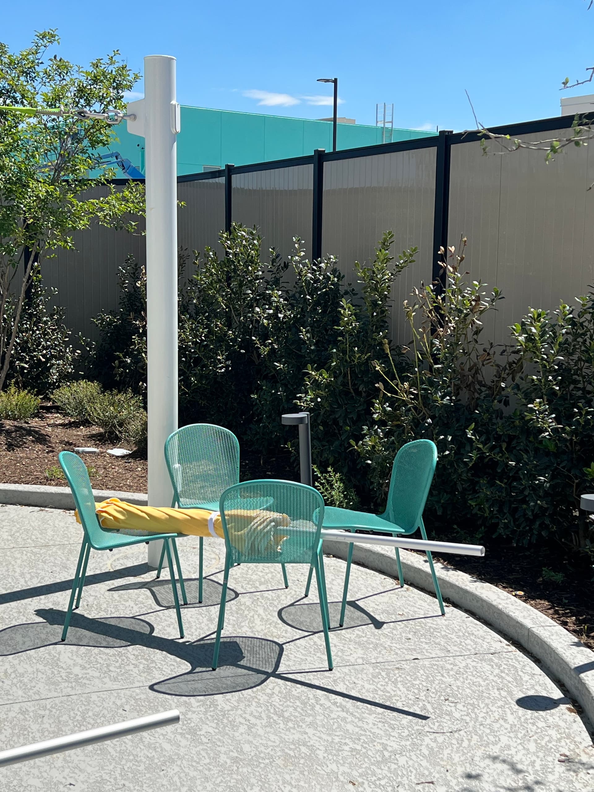 Eight-foot-tall vertical vinyl privacy fence in a Perimtec Steel Frame commercial installation