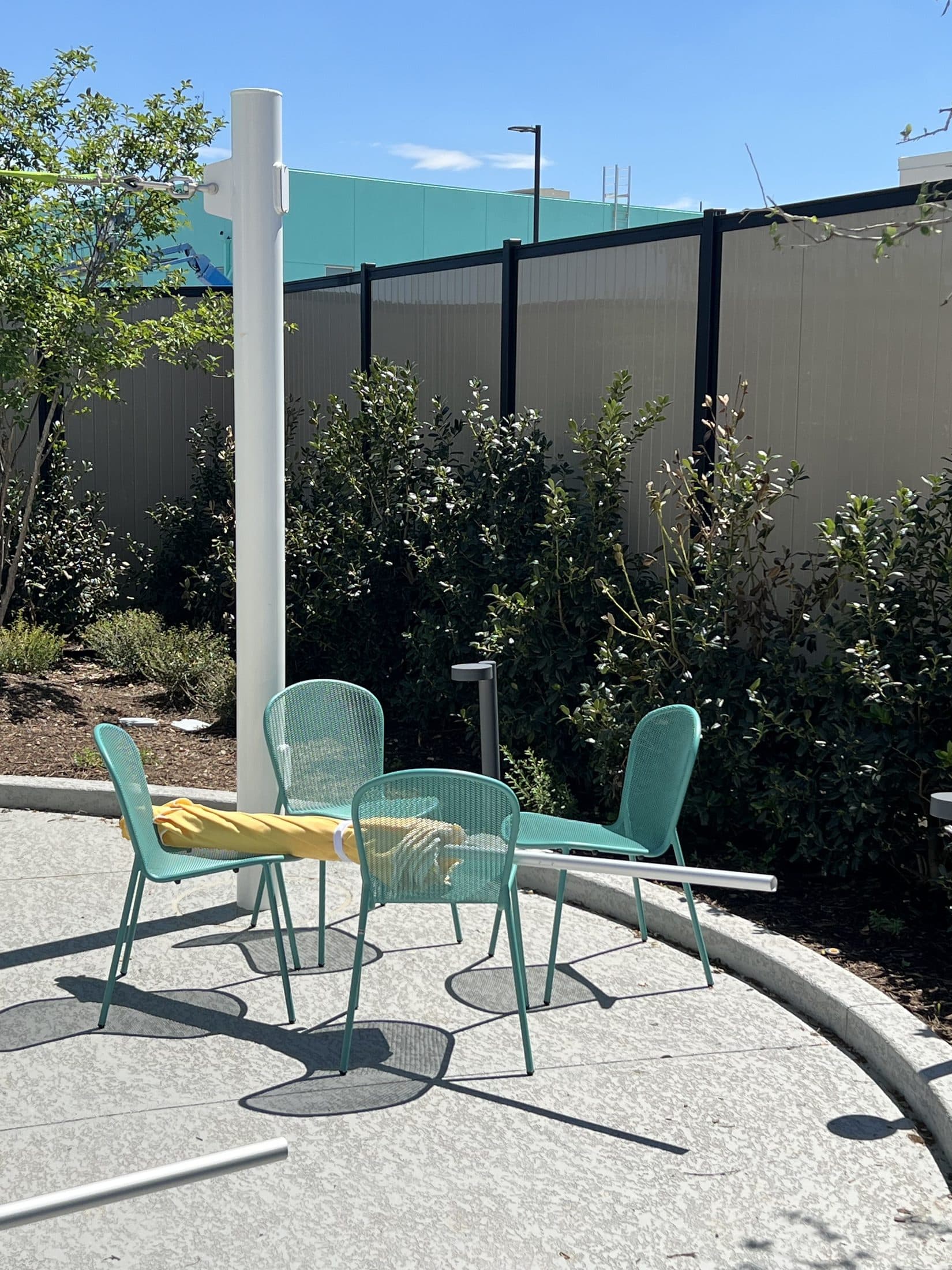 Eight-foot-tall vertical vinyl privacy fence in a Perimtec Steel Frame commercial installation