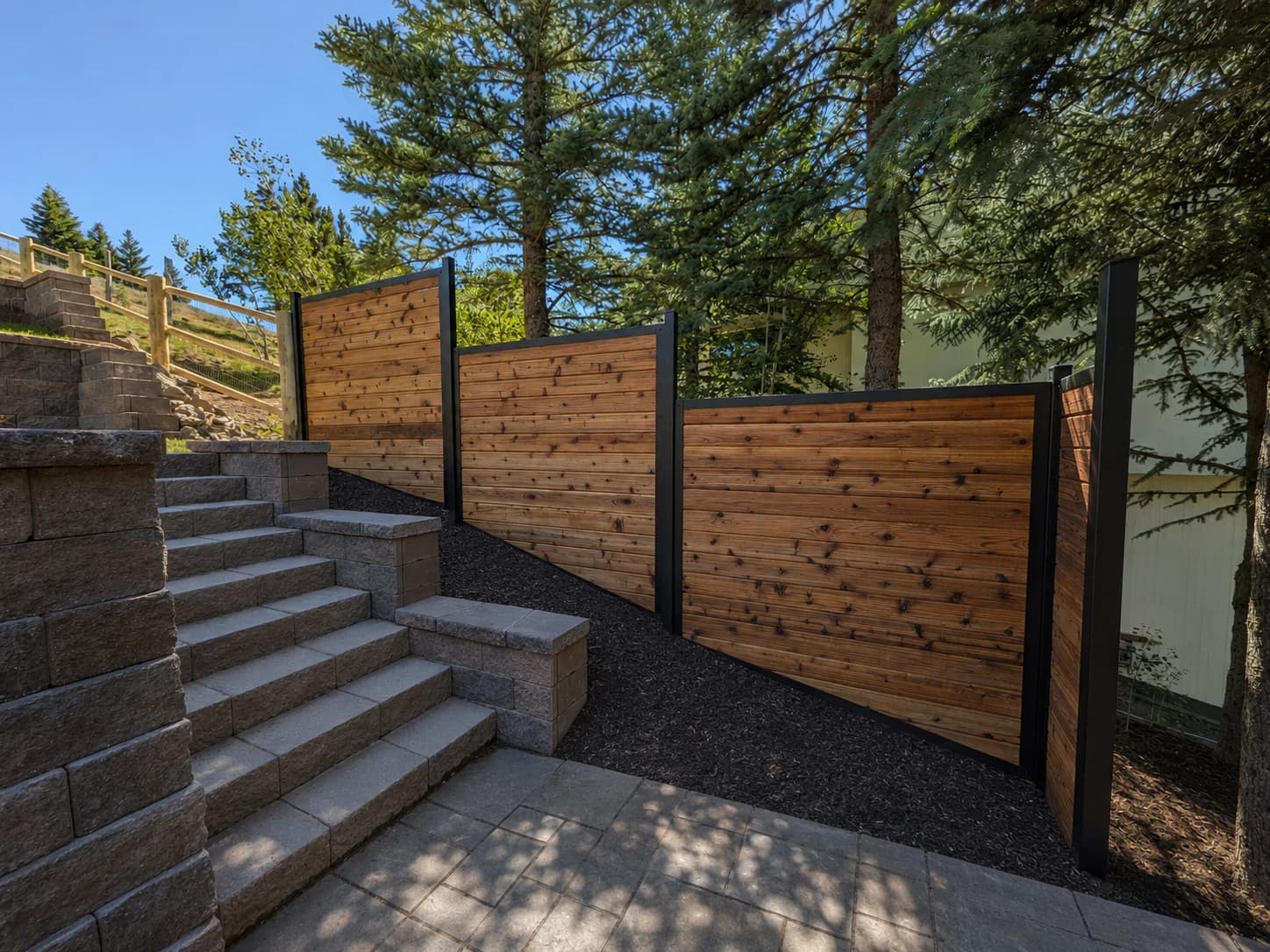 Steel Frame cedar fence following a sloped residential grade.