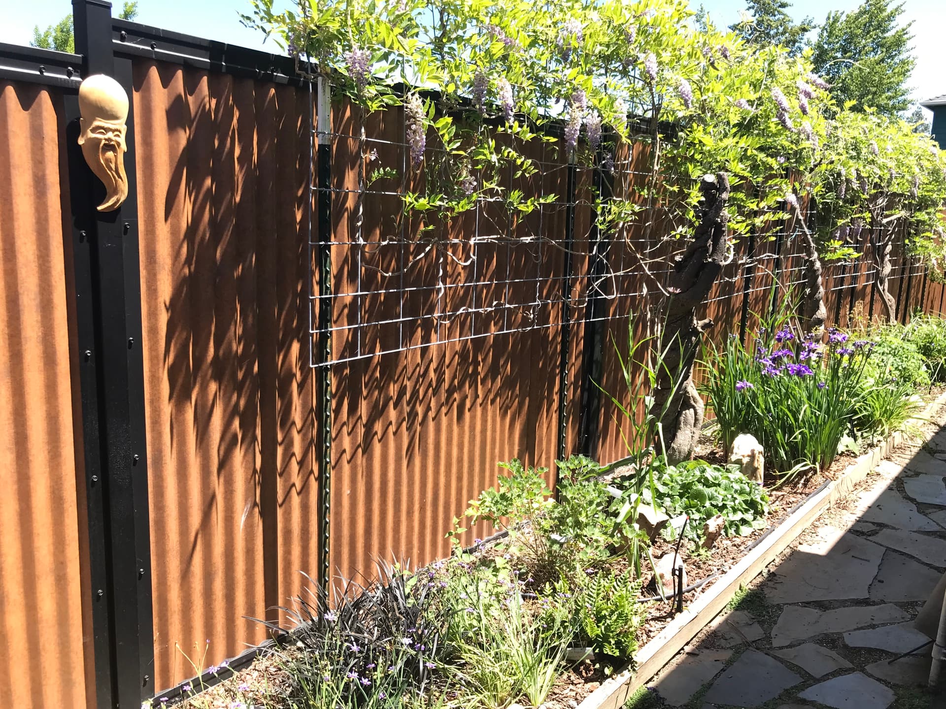Modern corrugated metal privacy fence in a galvanized steel frame