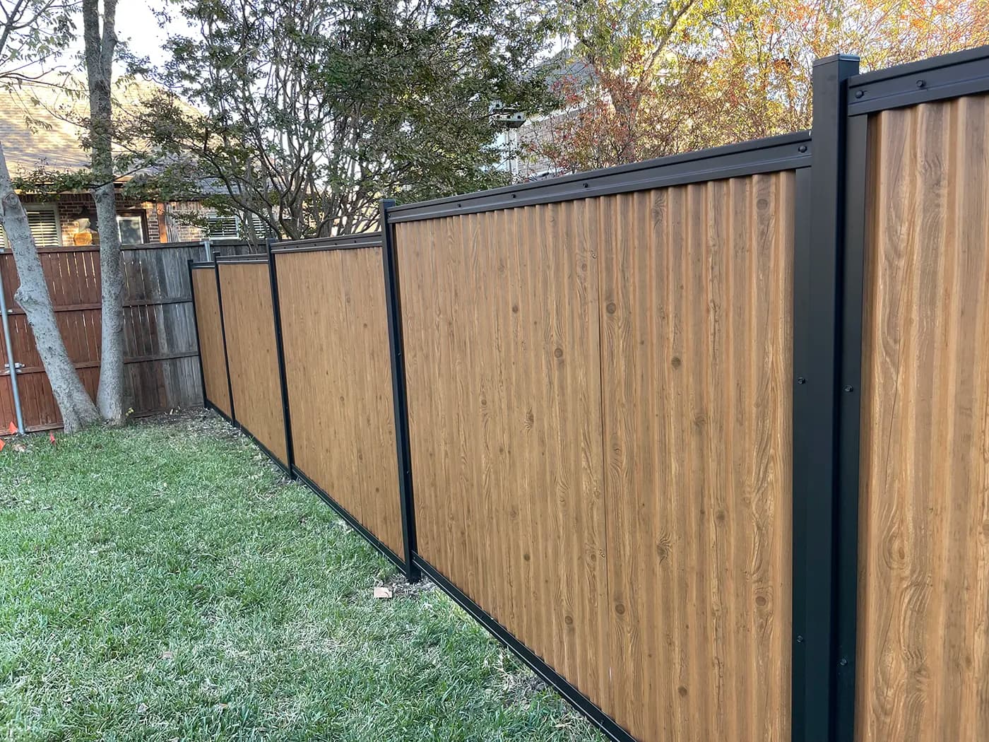Vintage Pine wood-look designer metal fence panel in a Perimtec framed system.