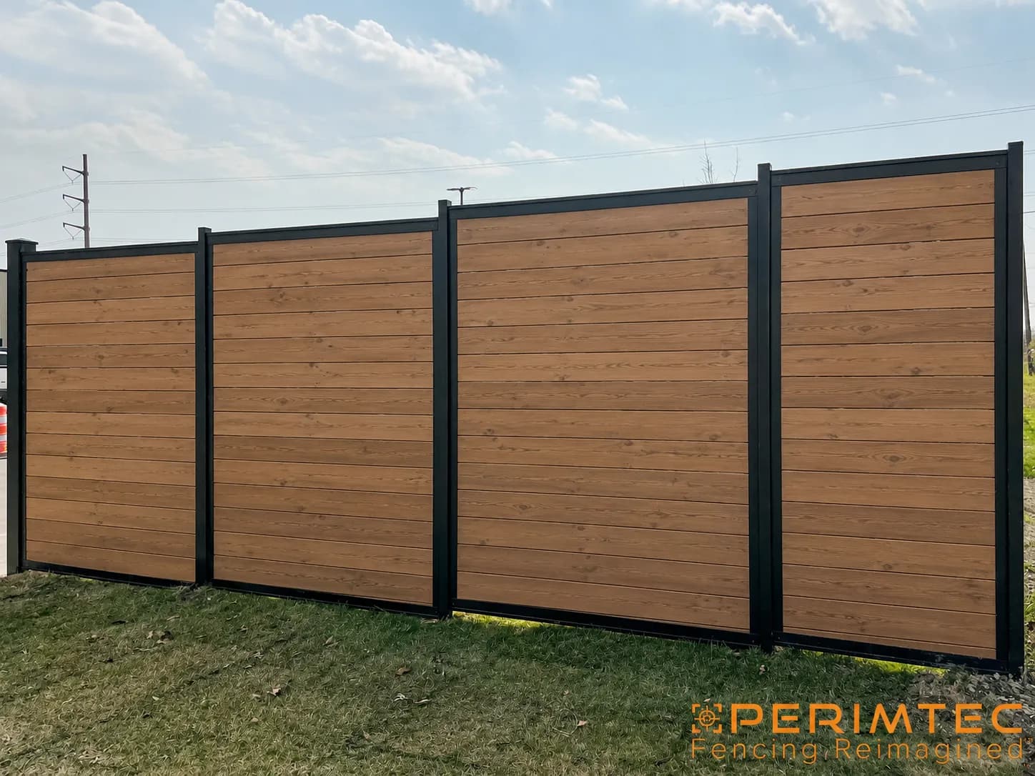 Eight-foot-tall Perimtec Steel Frame privacy fence with horizontal stained cedar infill