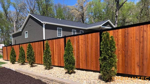 Steel frame fence system with composite infill and modern framing lines.