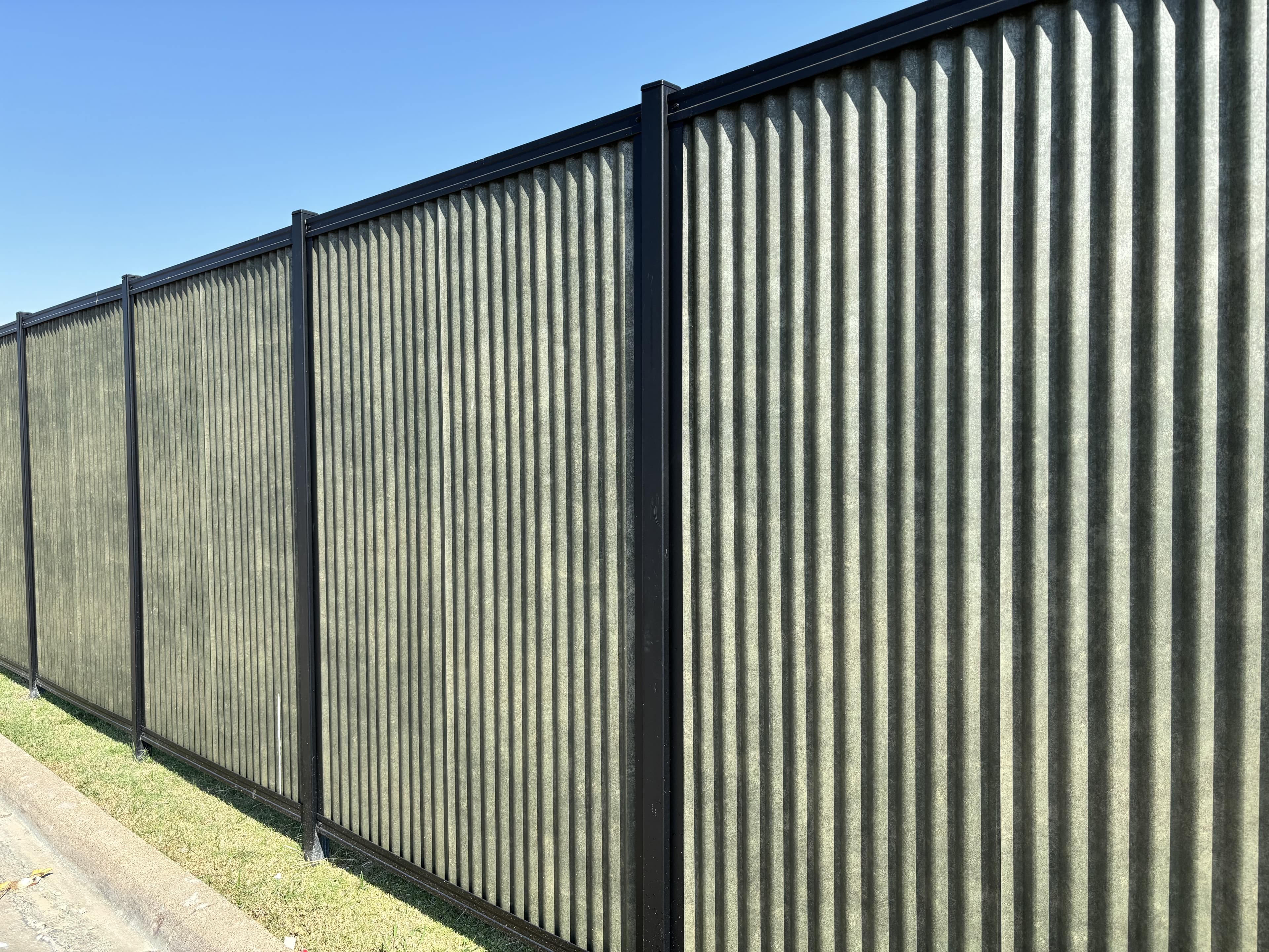 Commercial perimeter fence run with modern framed sections and clean alignment.
