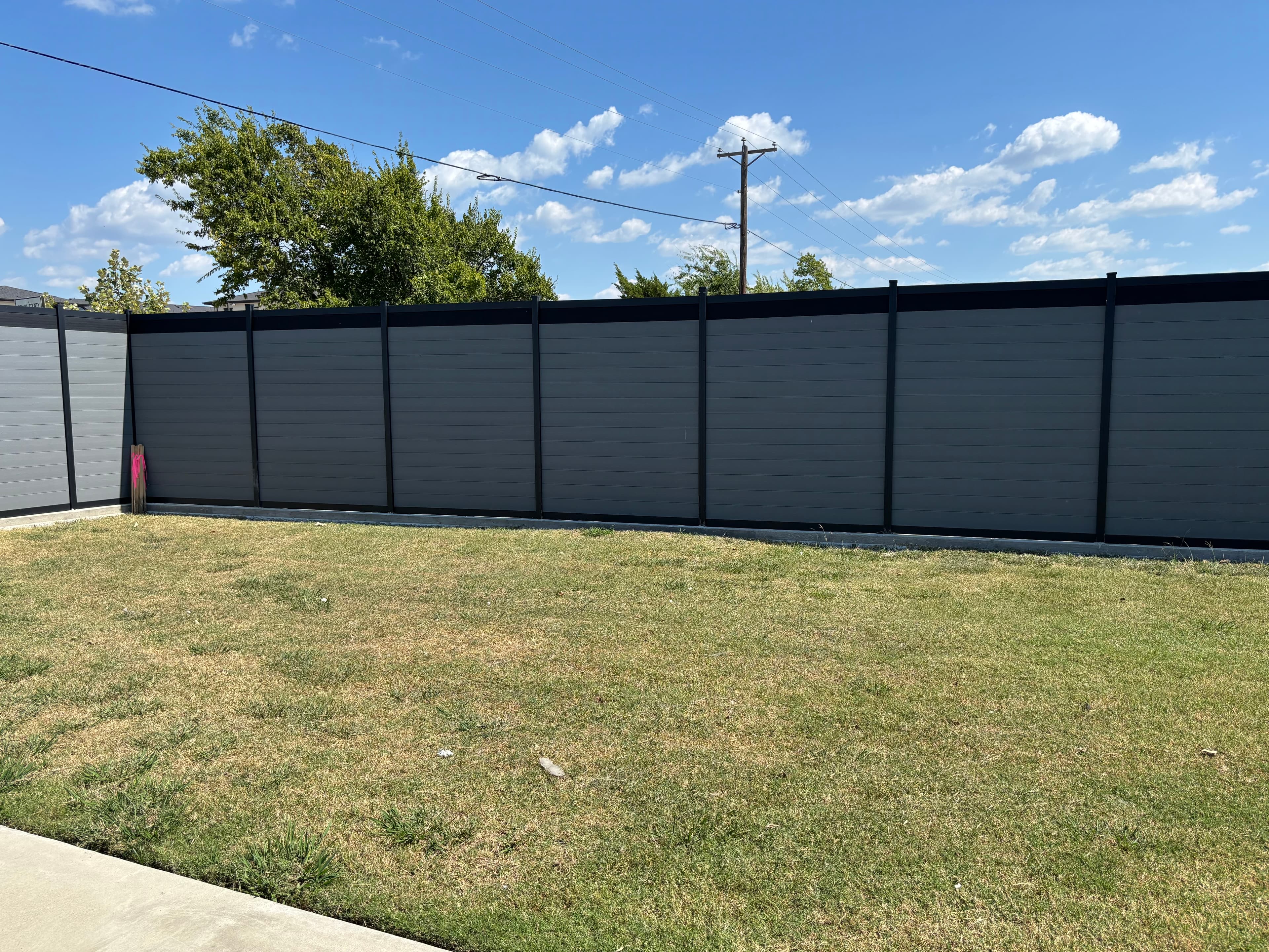 Powder-coated aluminum frame fence with crisp modern geometry.