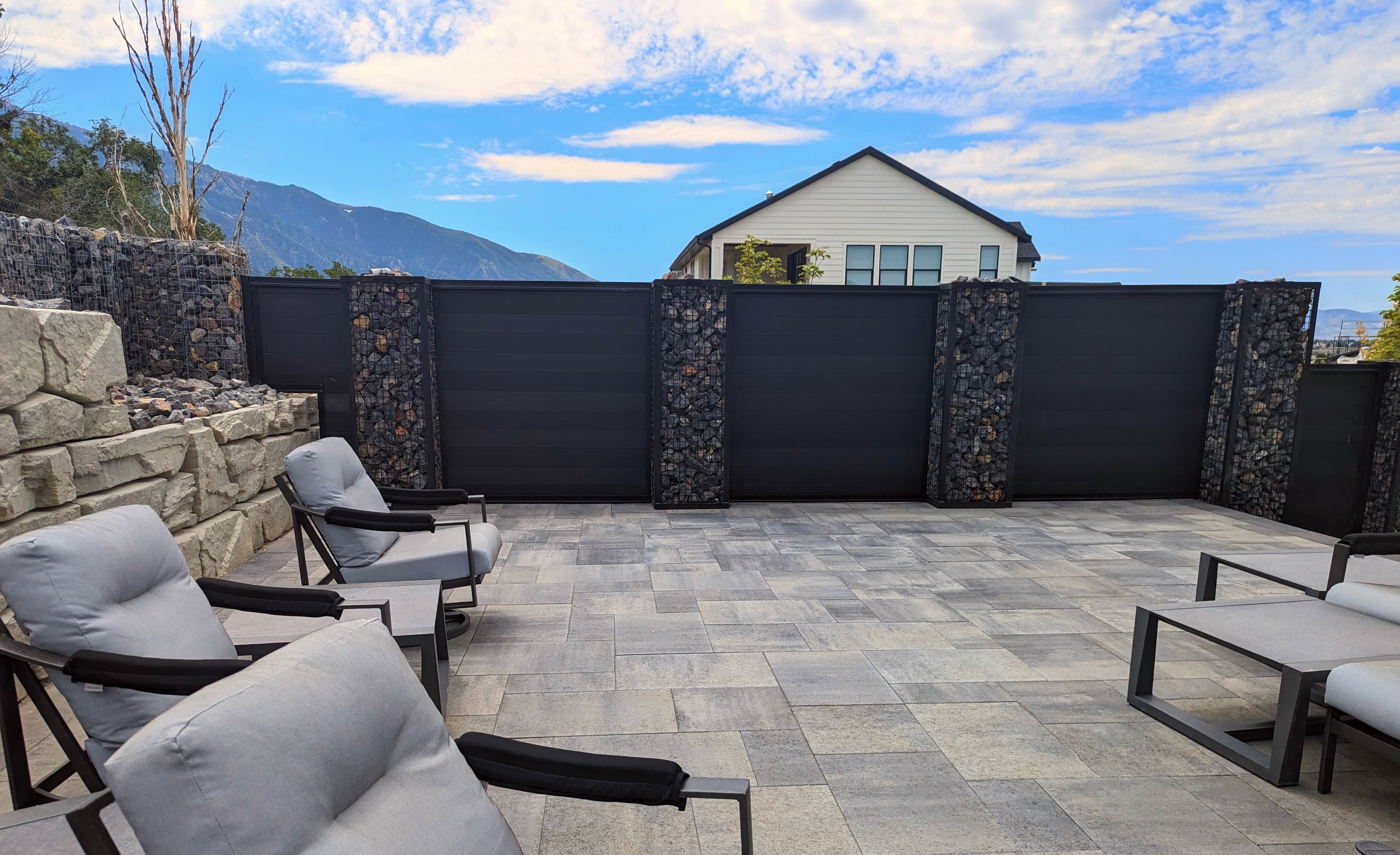 Contemporary steel-framed privacy fence with landscaped courtyard.