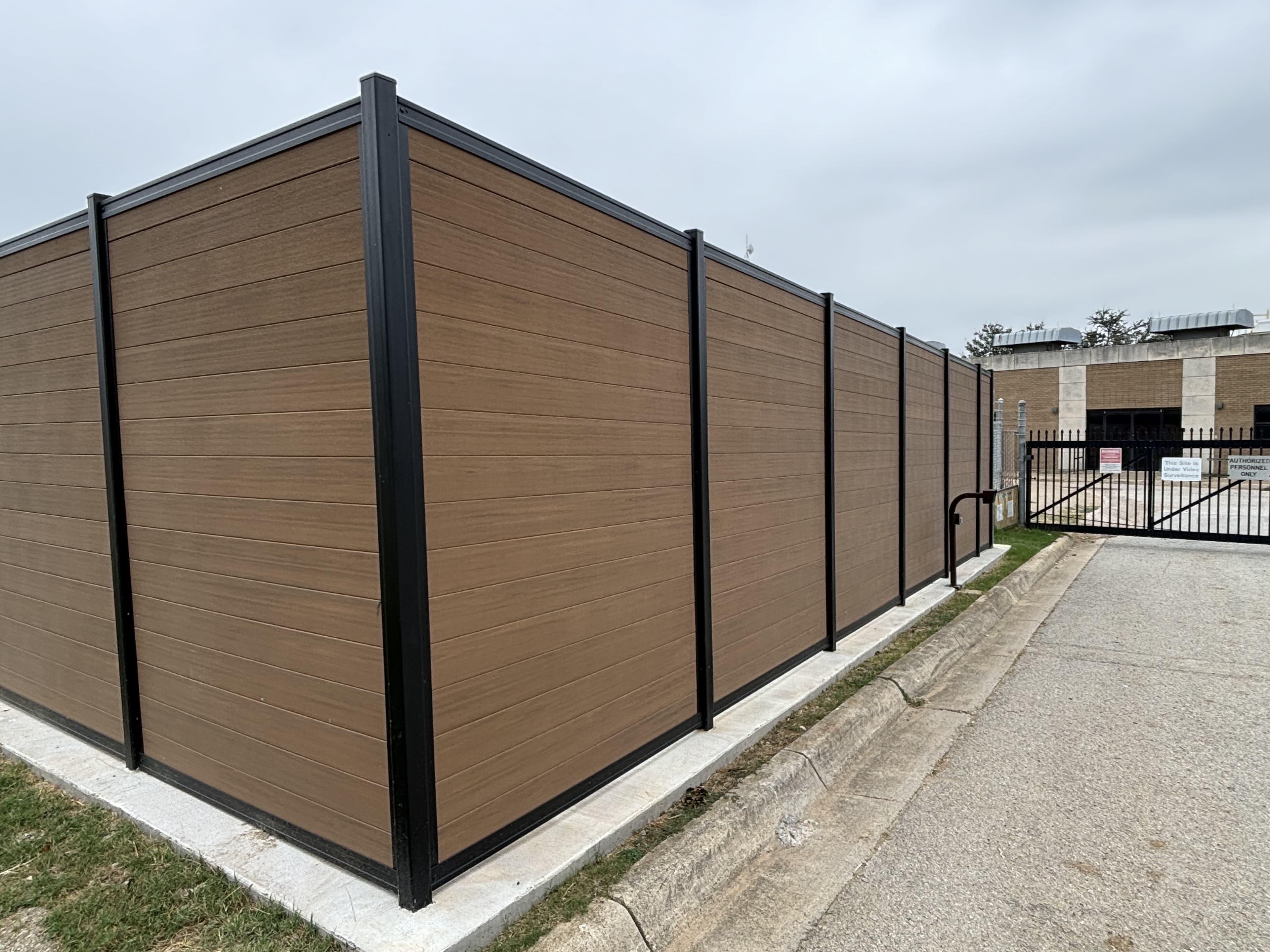 Long commercial perimeter fence run with modern steel framing.