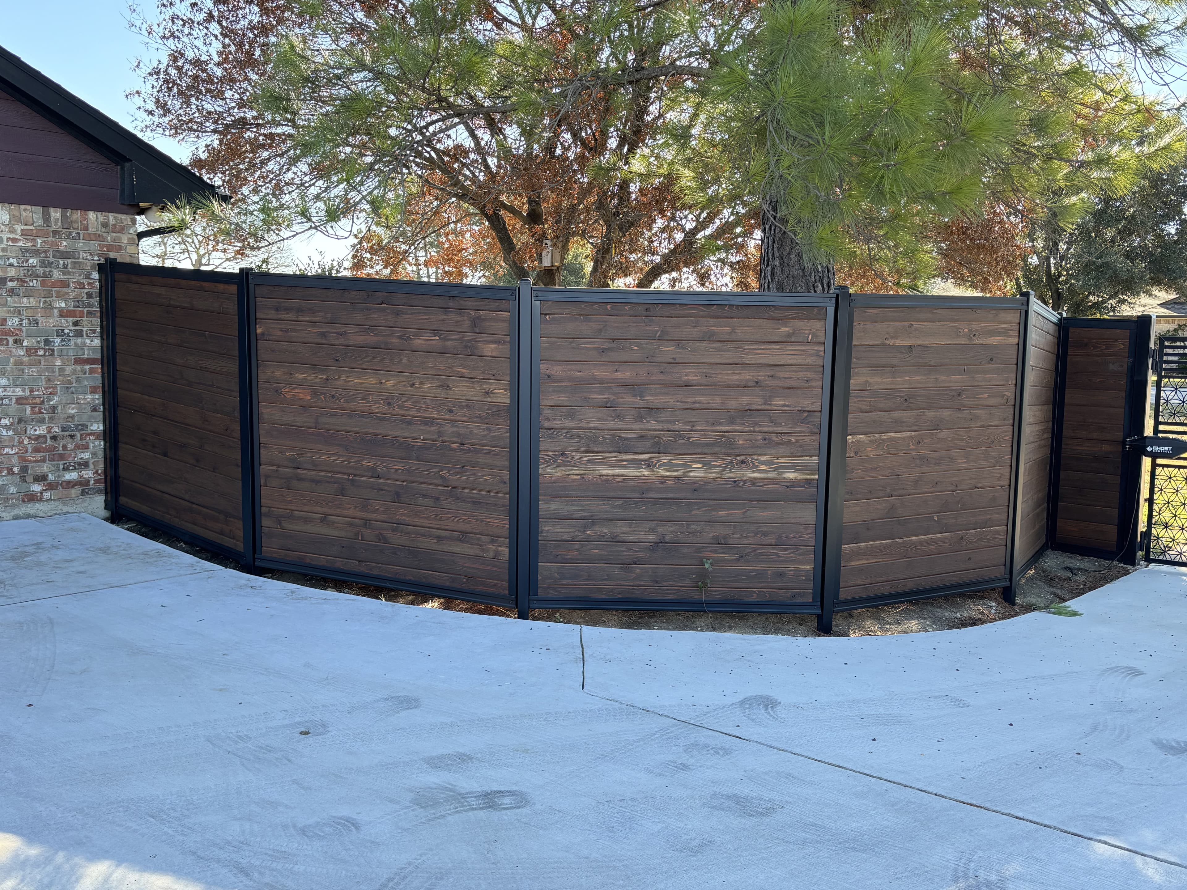 Steel frame fence system installation highlighting clean lines and long run continuity.