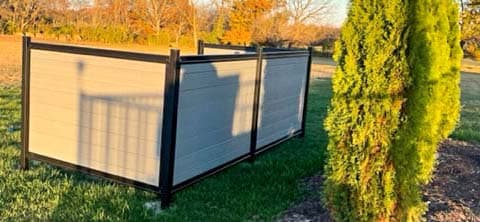 Contained equipment screening area using framed modern fencing for cleaner site appearance.