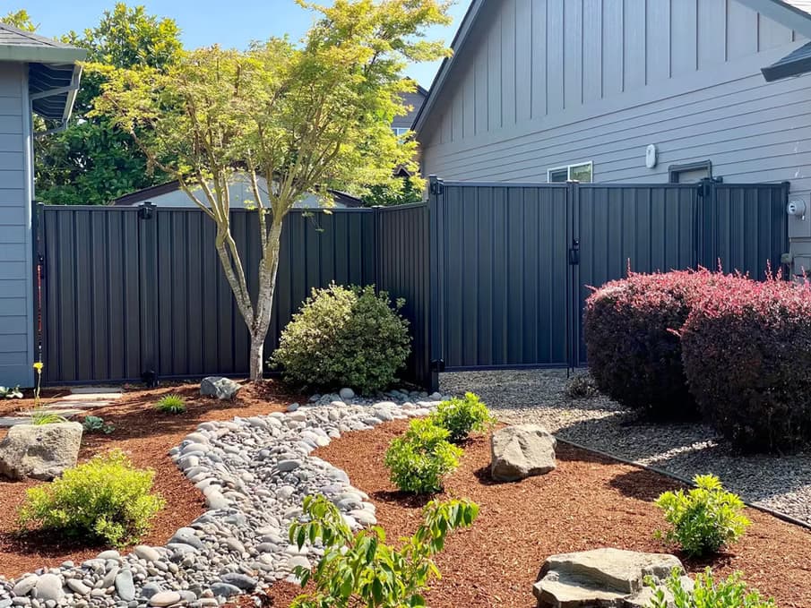 Modern residential backyard privacy fence with full visual screening.